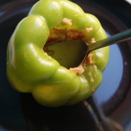 tamping minced meat into pepper